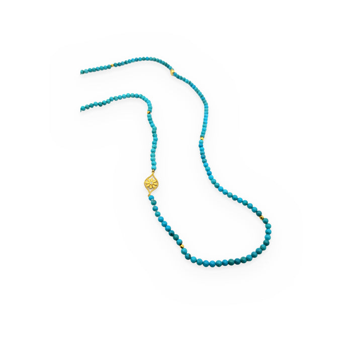 Long turquoise bead necklace with gold accent beads and a diamond-set gold flower station